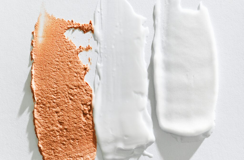 Three textured cosmetic cream swatches illustrating the use of lanolin in cosmetic formulations.