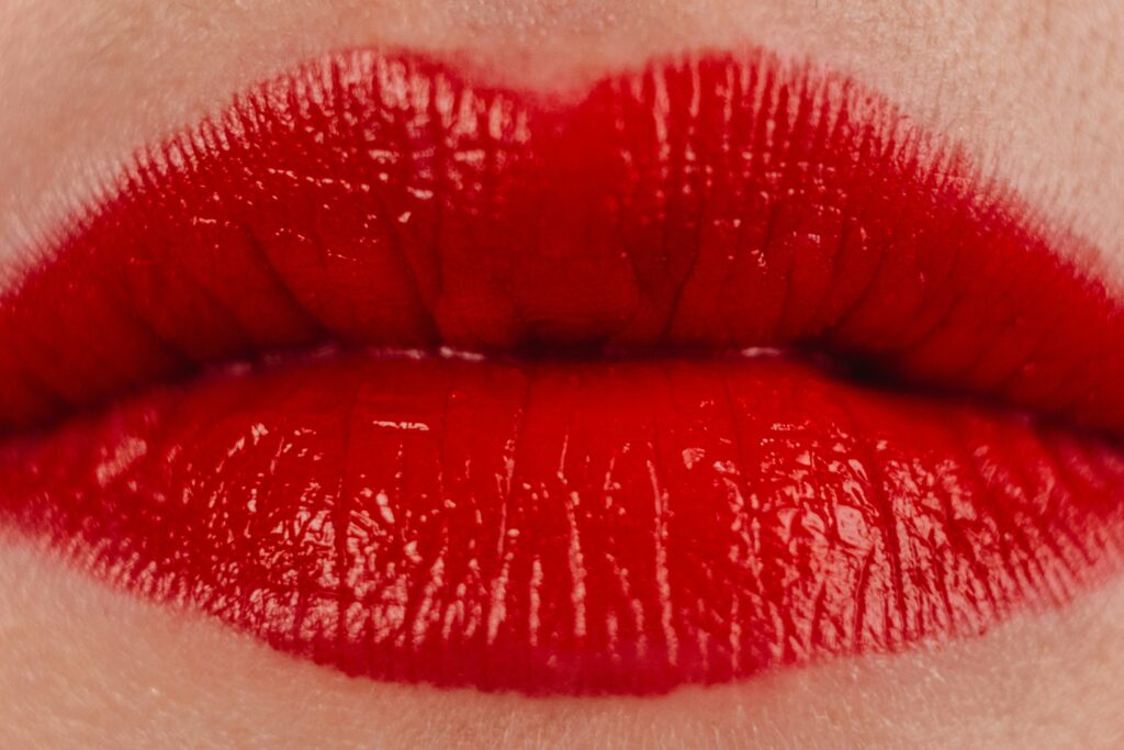 Red lipstick on lips illustrating a decorative cosmetics application of Lanolin Hydrogenated.