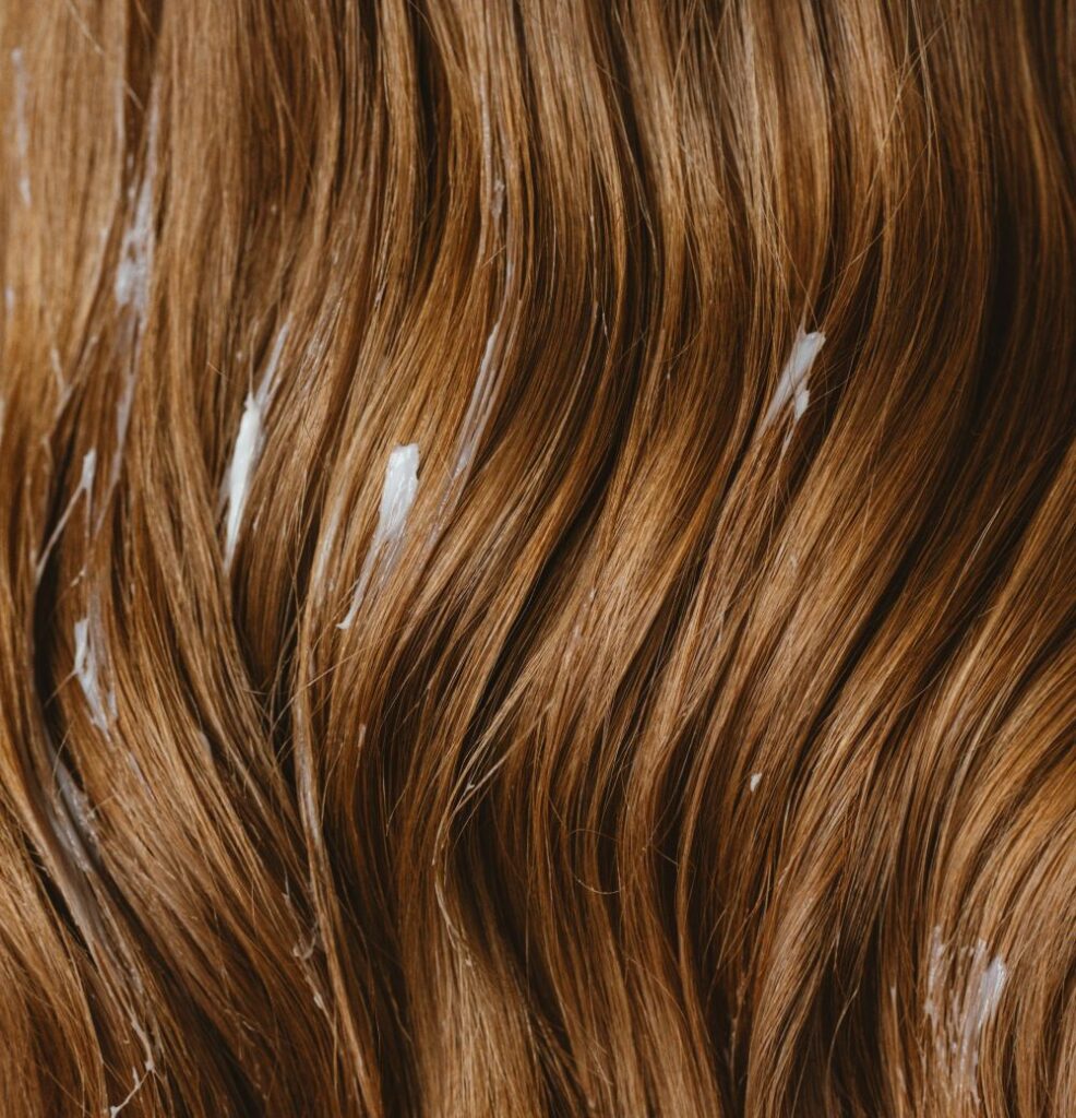 Hair care treatment applied to the hair, illustrating a personal care application of Lanolin Oil.