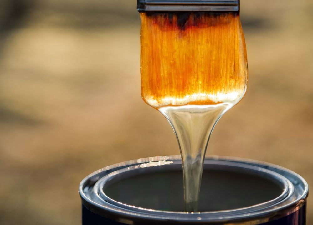 Brush applying a coating, illustrating applications of lanolin in coatings and surface treatment