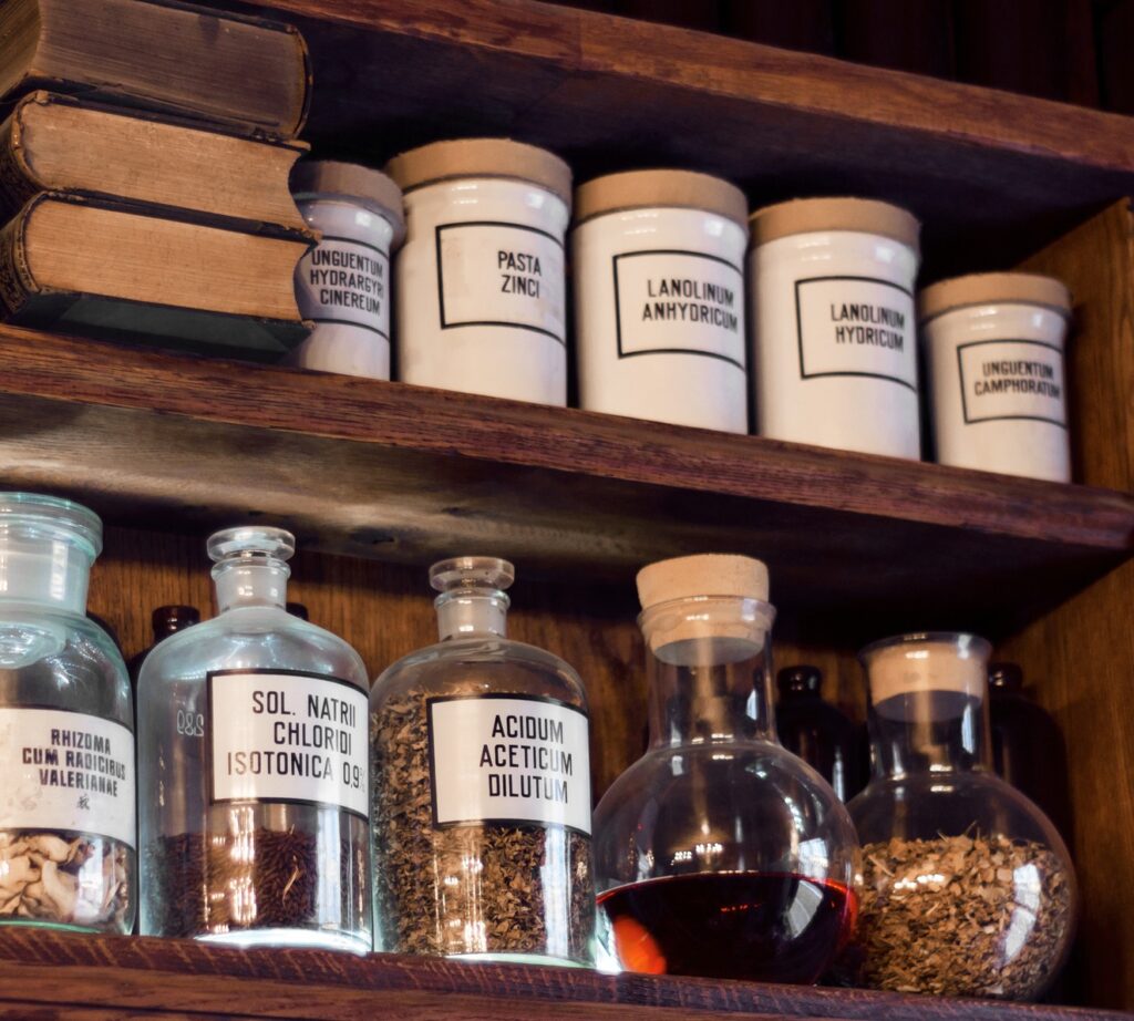 Historical apothecary bottles and pharmaceutical containers, illustrating the long history of wool-derived preparations and lanolin use.